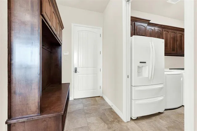 a kitchen with stainless steel appliances granite countertop a stove and a refrigerator