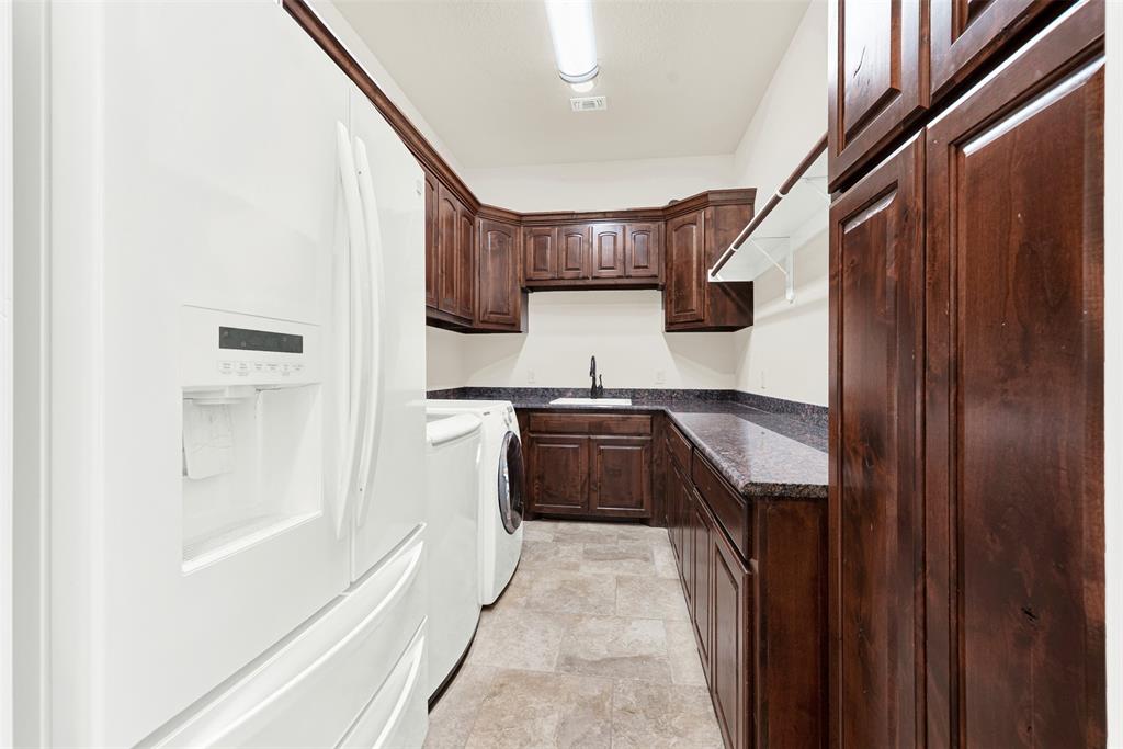 834 Audra Circle Rhome, TX 76078 - Photo 21 of 33 a kitchen with stainless steel appliances granite countertop a stove and a refrigerator