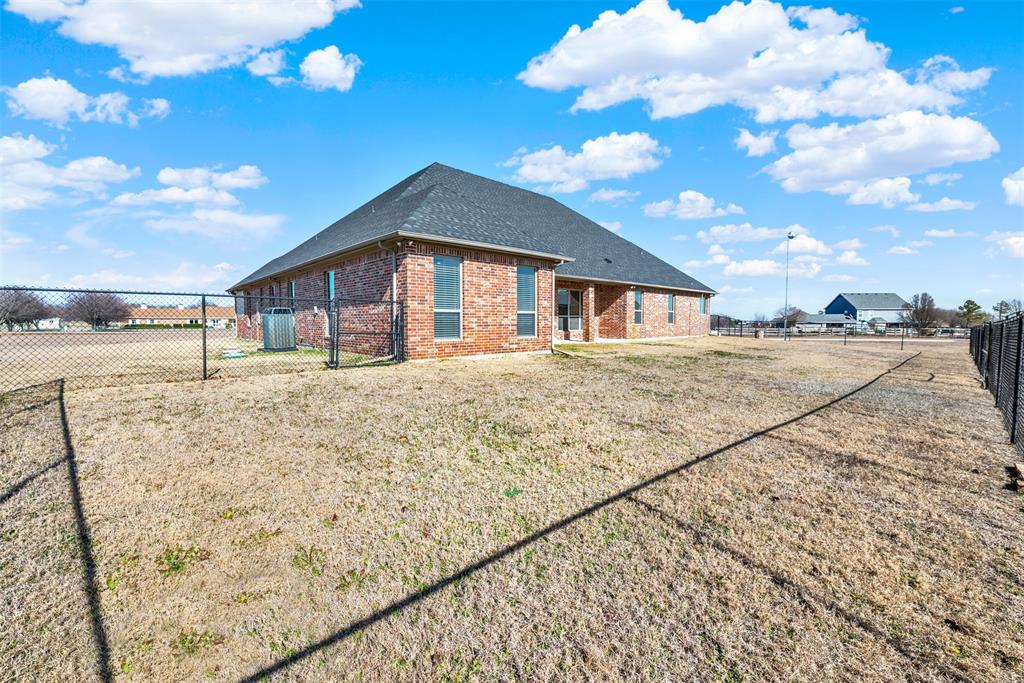 834 Audra Circle Rhome, TX 76078 - Photo 23 of 33 a big house with a big yard and large trees