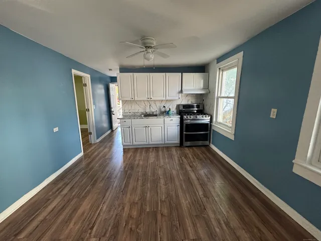 a kitchen with wooden floors and appliances