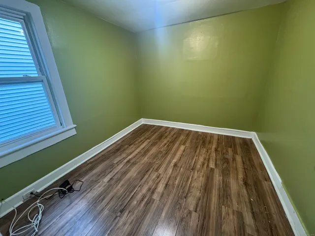 a view of a room with wooden floor