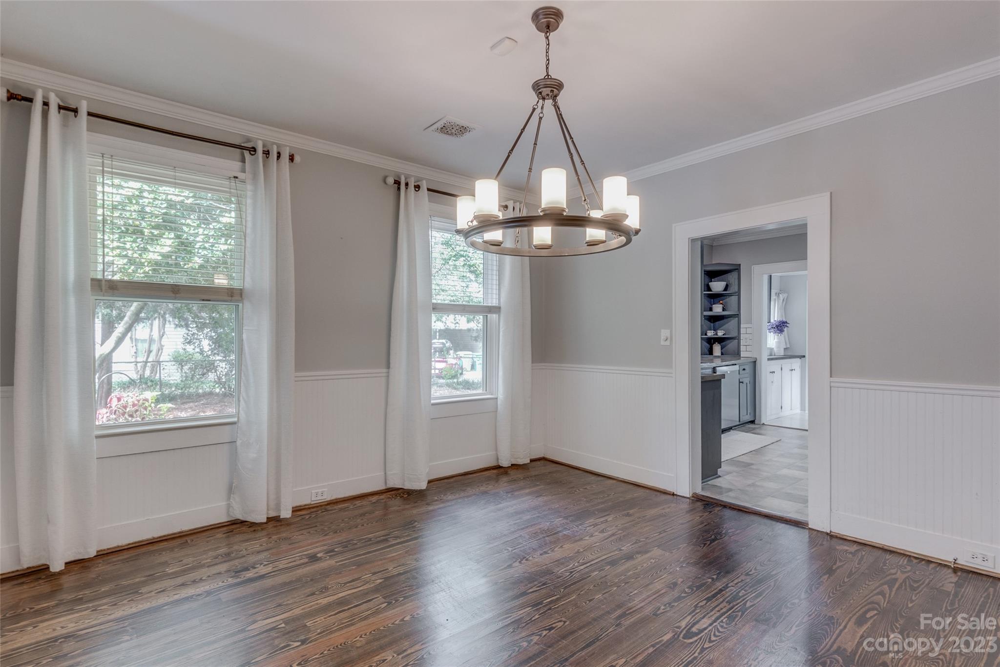 102 Grier Street Fort Mill, SC 29715 - Photo 14 of 47 a view of a chandelier in a room with wooden floor and windows