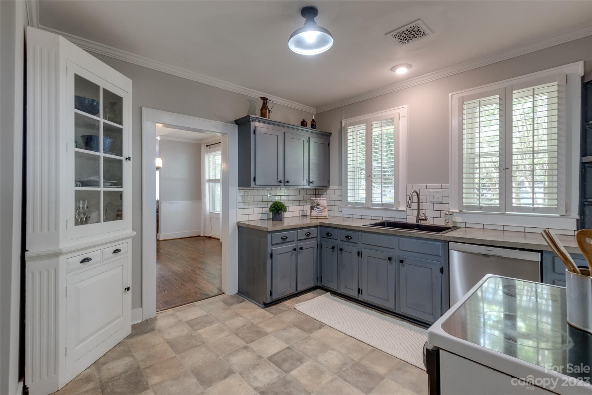 102 Grier Street Fort Mill, SC 29715 - Photo 16 of 47 a large kitchen with kitchen island granite countertop a large window and stainless steel appliances