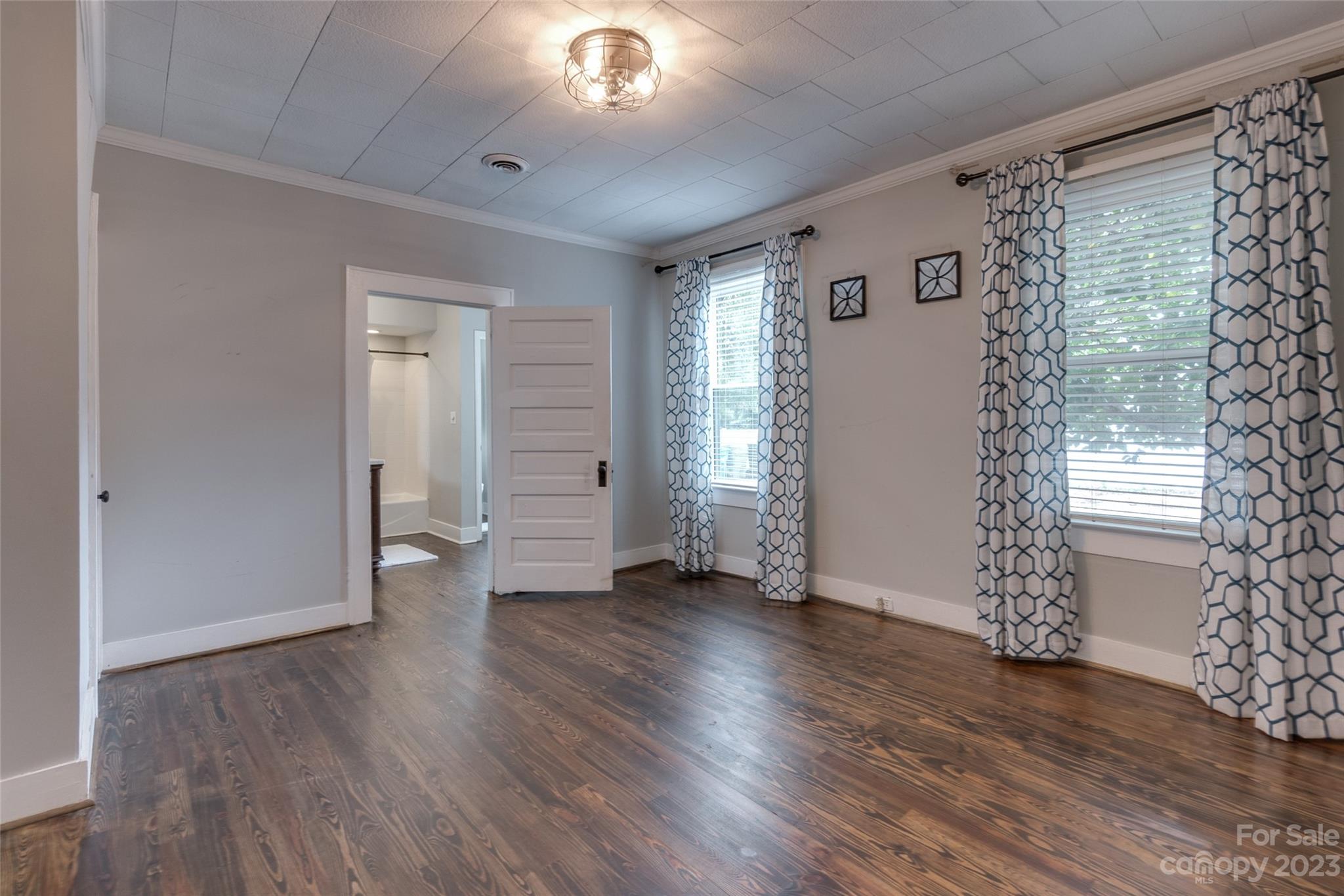 102 Grier Street Fort Mill, SC 29715 - Photo 29 of 47 an empty room with wooden floor and windows