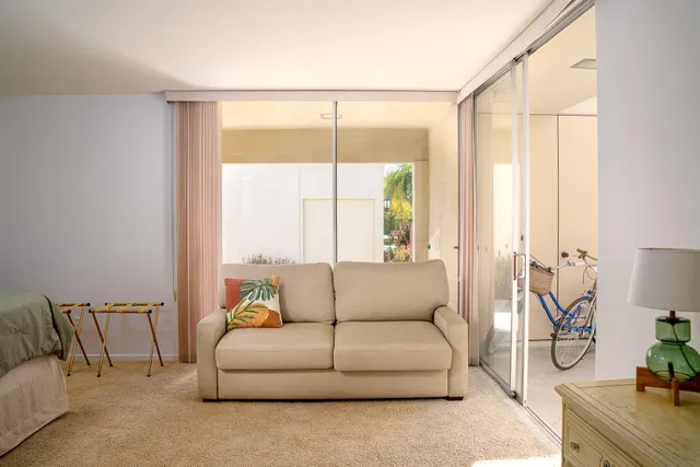 a view of a house with a big yard and potted plants