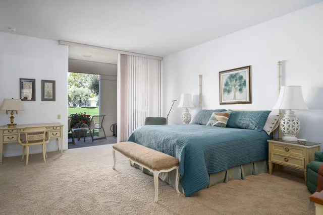 a front view of a house with a big yard and potted plants