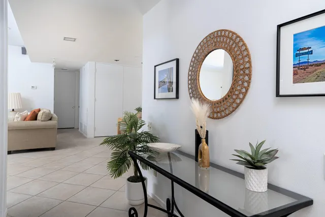 a kitchen with white cabinets and window