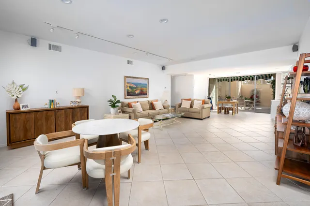 a dining room with furniture water view and a garden