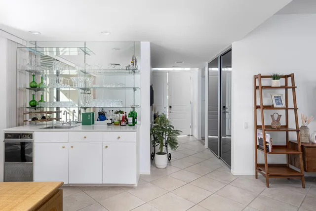 a kitchen with stainless steel appliances granite countertop a refrigerator a stove and white cabinets