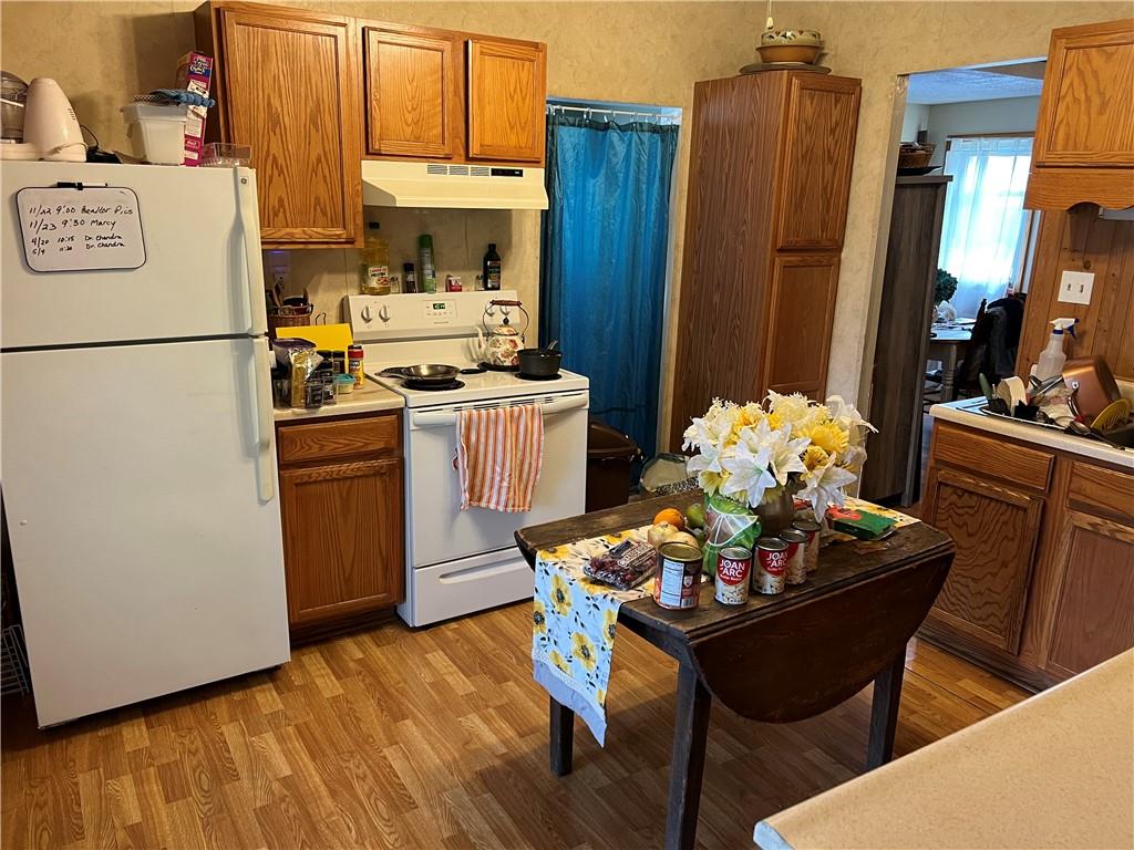 939 Orchard Street Rochester, PA 15074 - Photo 4 of 9 a kitchen with a table chairs and refrigerator