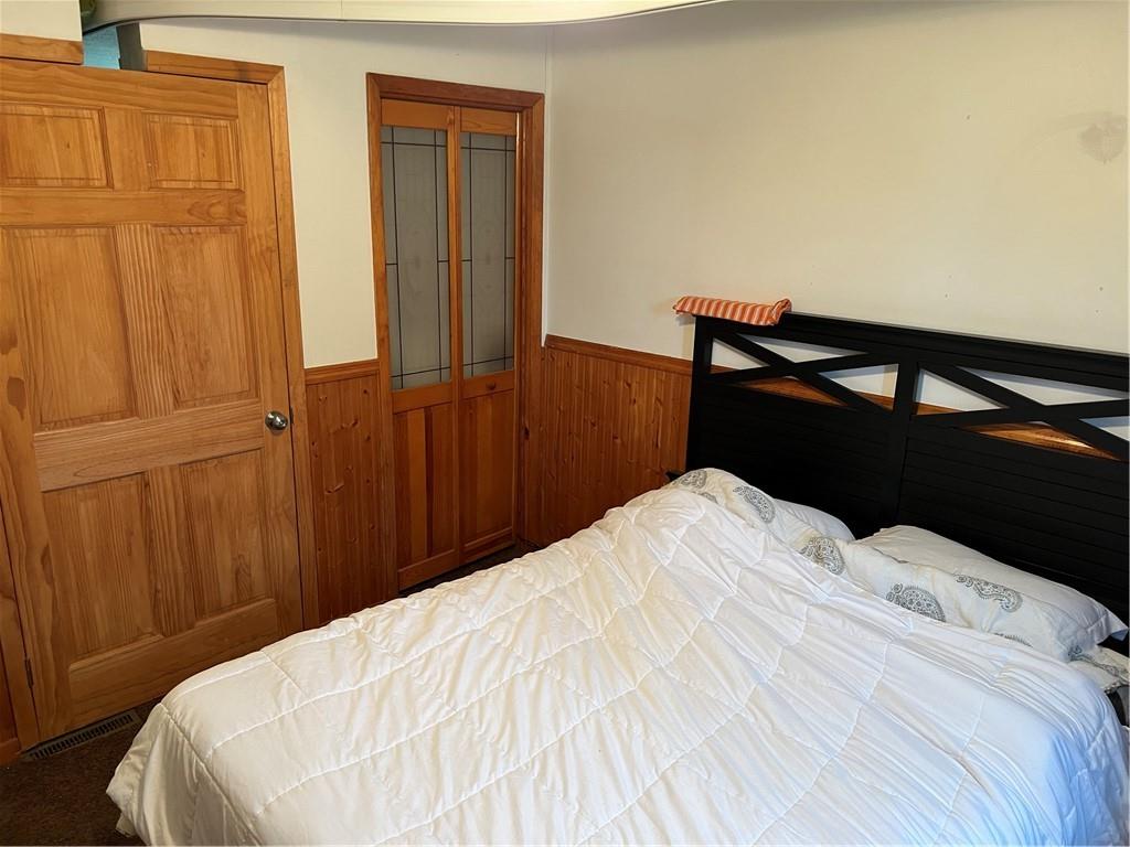 939 Orchard Street Rochester, PA 15074 - Photo 6 of 9 a bedroom with a bed and wooden floor