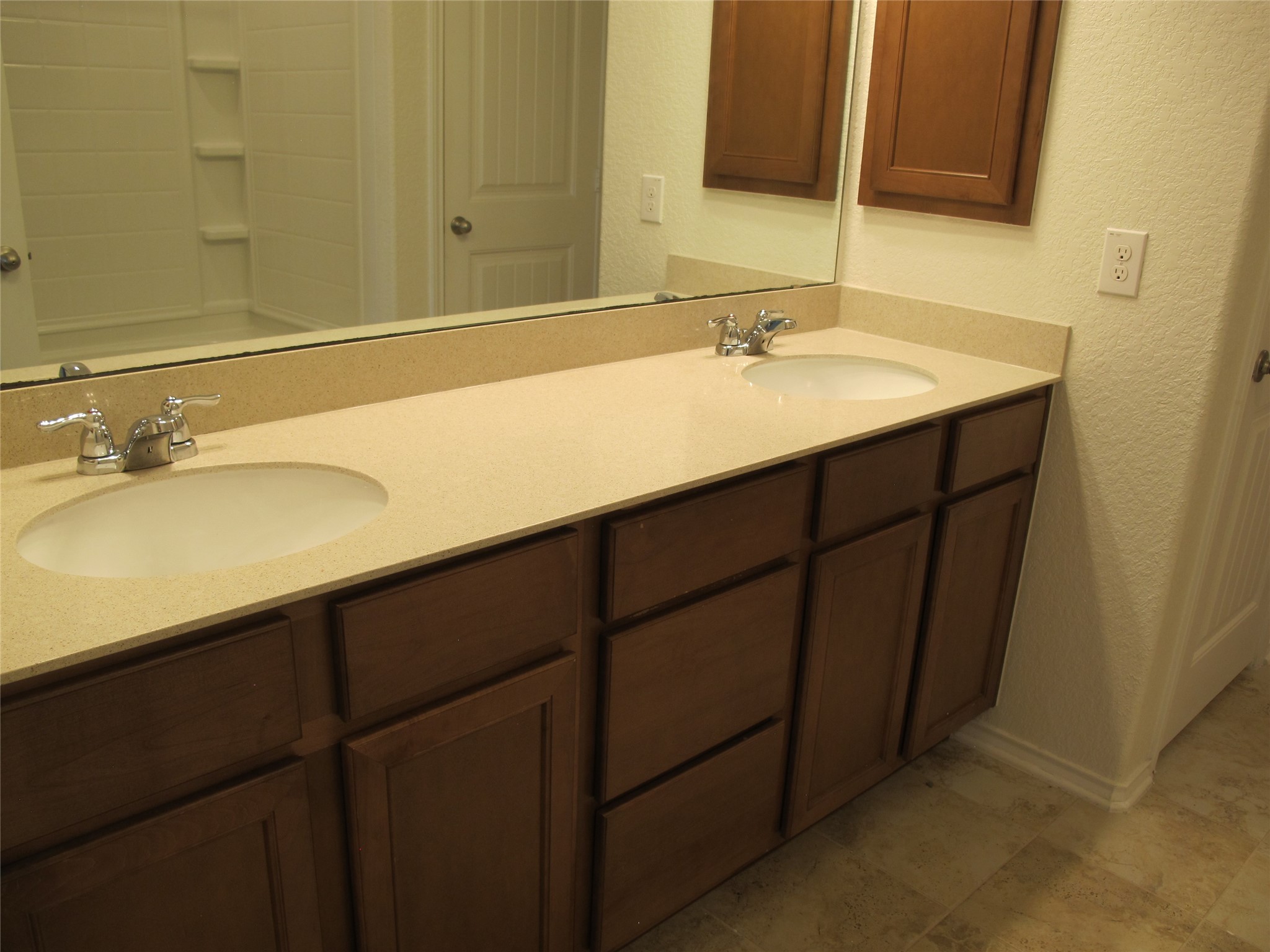7820 Big Wind Way Austin, TX 78724 - Photo 22 of 37 Bathroom with a textured wall and double vanity