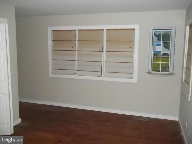 23005 Carrollton Road Neavitt, MD 21652 - Photo 15 of 21 an empty room with wooden floor and windows