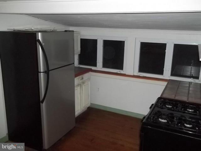 23005 Carrollton Road Neavitt, MD 21652 - Photo 4 of 21 a kitchen with a refrigerator and a stove