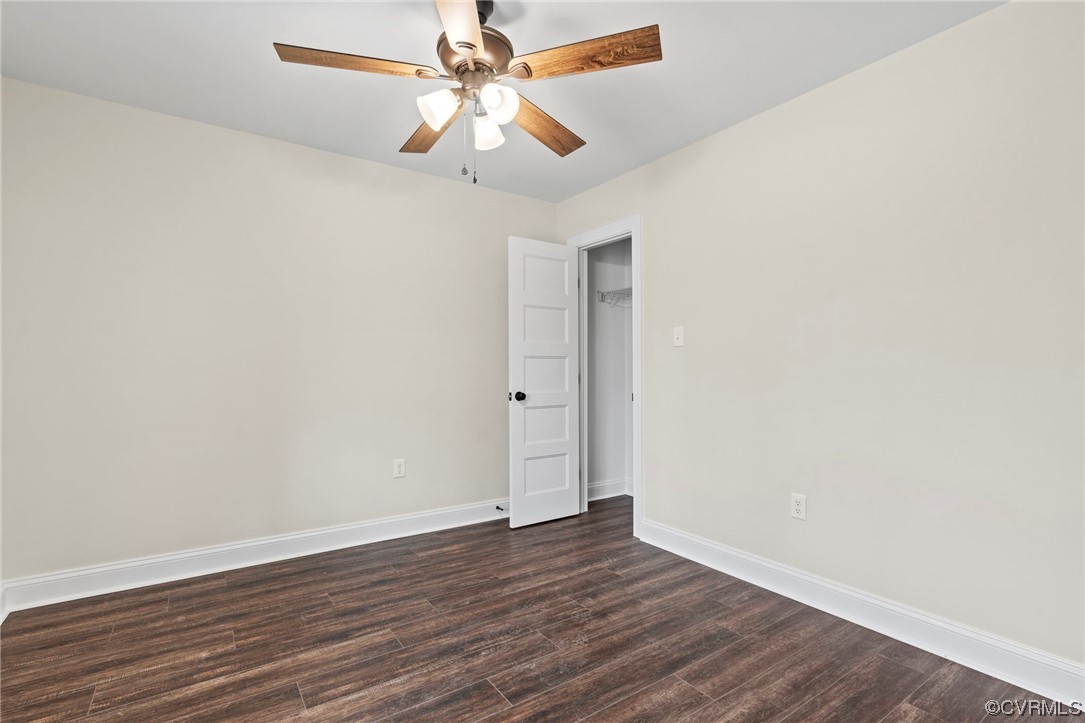 1548 Cartersville Road Goochland, VA 23063 - Photo 19 of 33 an empty room with wooden floor and fan