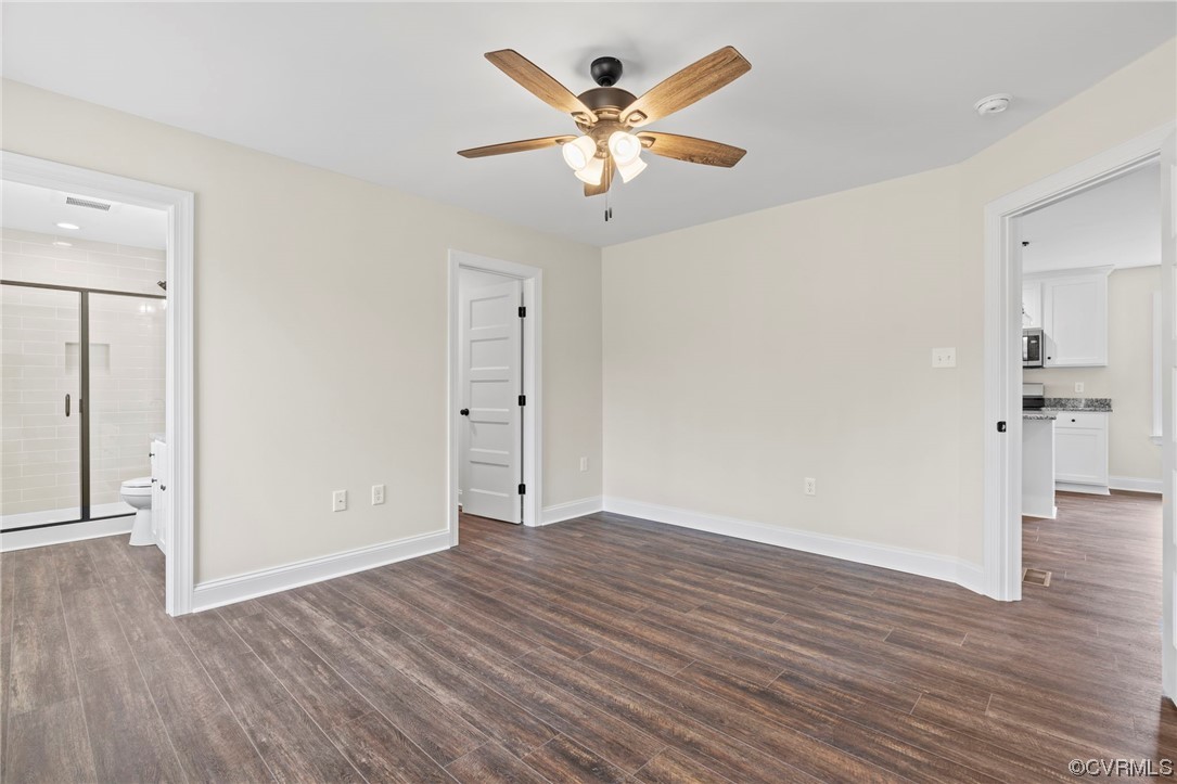 1548 Cartersville Road Goochland, VA 23063 - Photo 25 of 33 an empty room with wooden floor and ceiling fan