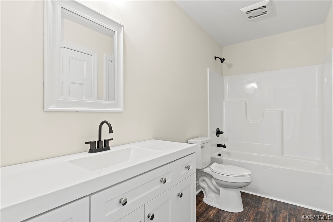 1548 Cartersville Road Goochland, VA 23063 - Photo 30 of 33 a bathroom with a toilet sink a mirror and shower