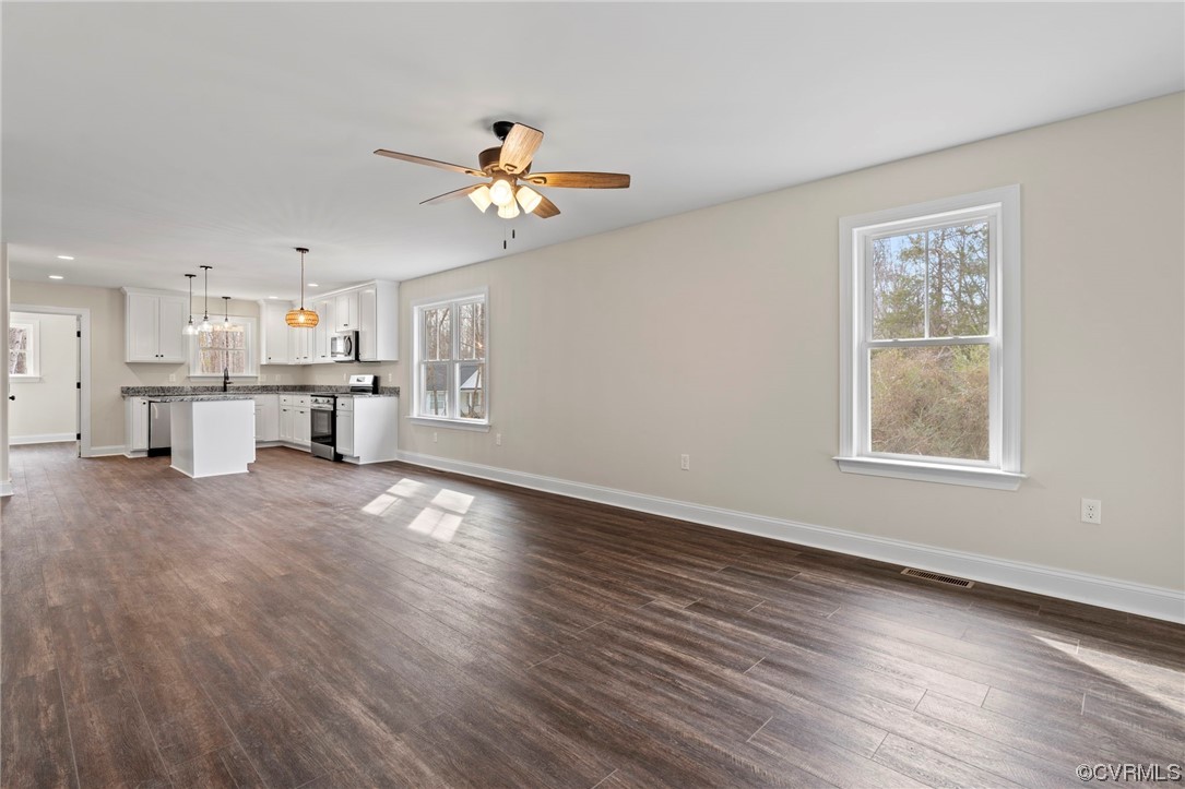 1548 Cartersville Road Goochland, VA 23063 - Photo 6 of 33 a view of a kitchen with a stove cabinets a ceiling fan and wooden floor
