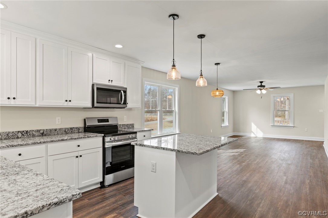 1548 Cartersville Road Goochland, VA 23063 - Photo 9 of 33 a kitchen with stainless steel appliances granite countertop a sink a stove and a wooden floors