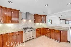a kitchen with stainless steel appliances granite countertop a stove sink and cabinets