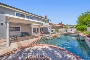 a view of a house with backyard sitting area and garden