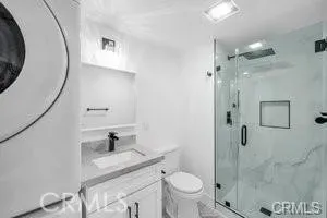 a bathroom with a granite countertop sink toilet and shower