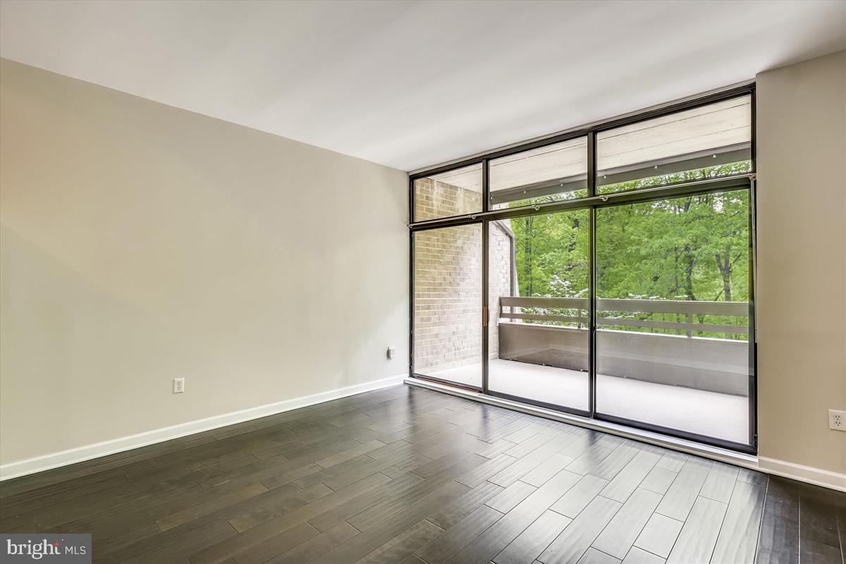 11564 Rolling Green Court, Unit 201 Reston, VA 20191 - Photo 9 of 29 Living Room w/ Tranquil Wooded View