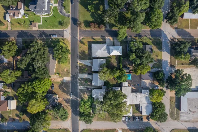 an aerial view of residential houses with outdoor space and river