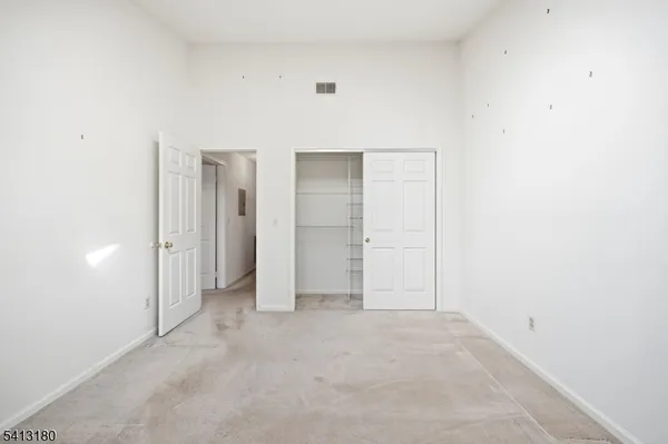 an empty room with closet area