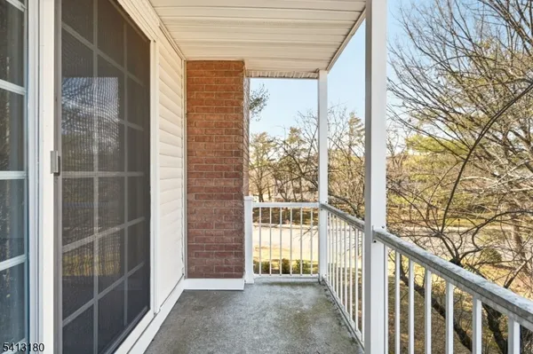 a view of a porch with wooden floor and fence