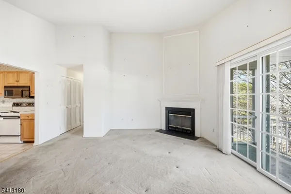 an empty room with furniture and a fireplace