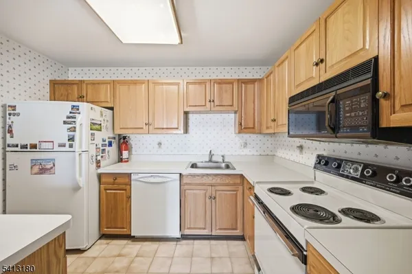 a kitchen with a stove a sink and a refrigerator