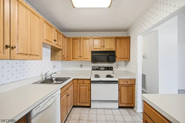 a kitchen with a sink a stove and cabinets