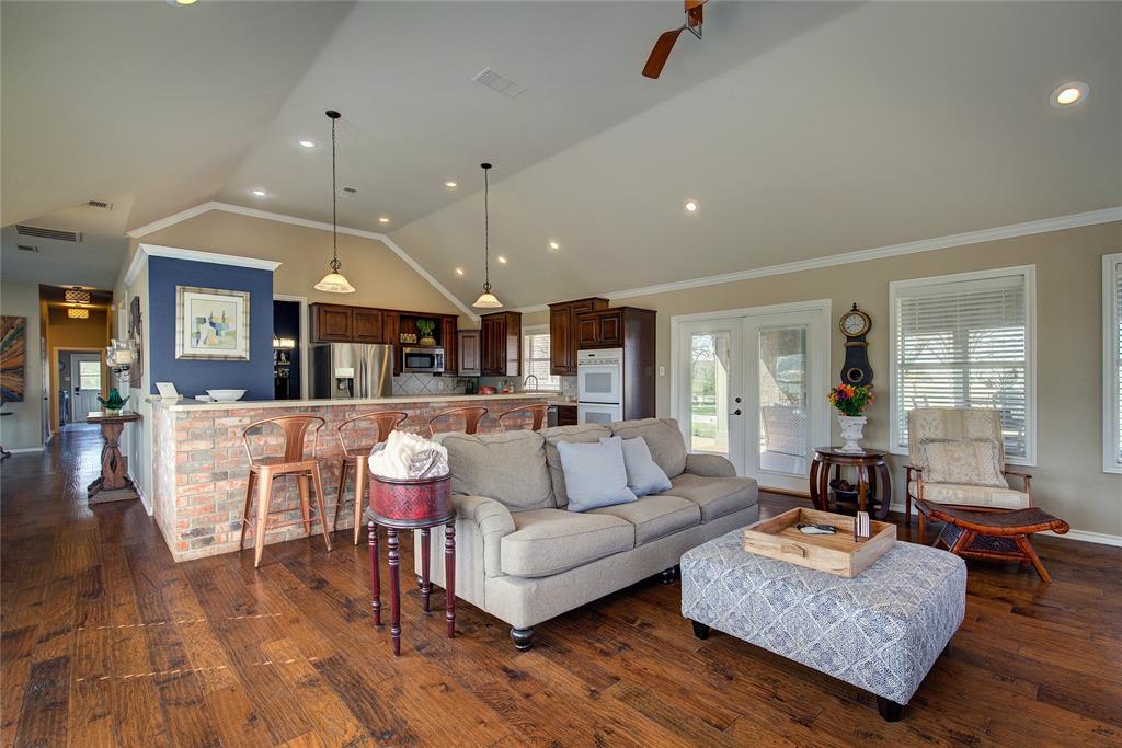 1079 Country Club Road Sulphur Springs, TX 75482 - Photo 14 of 40 a living room with furniture kitchen view and a wooden floor