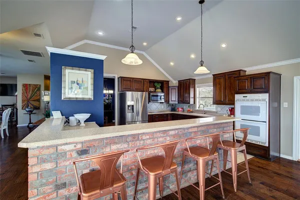 a large kitchen with a table and chairs
