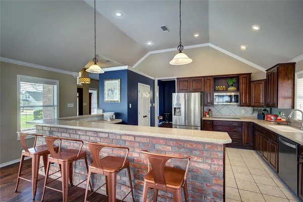 a kitchen with stainless steel appliances granite countertop a stove and a refrigerator