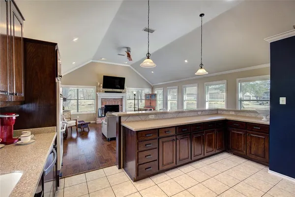 a kitchen with a kitchen island a sink stainless steel appliances and cabinets