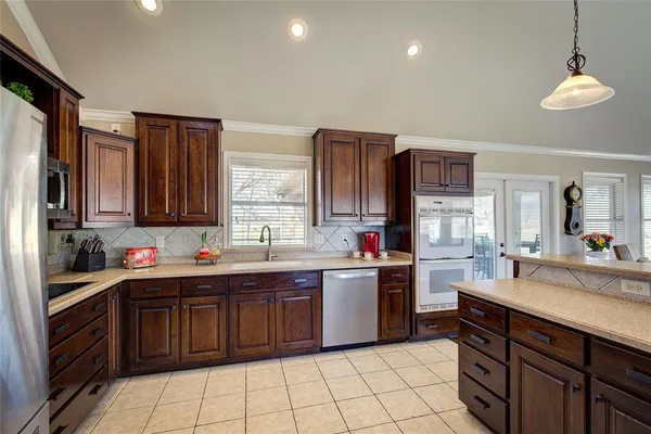 a kitchen with a sink stove and cabinets