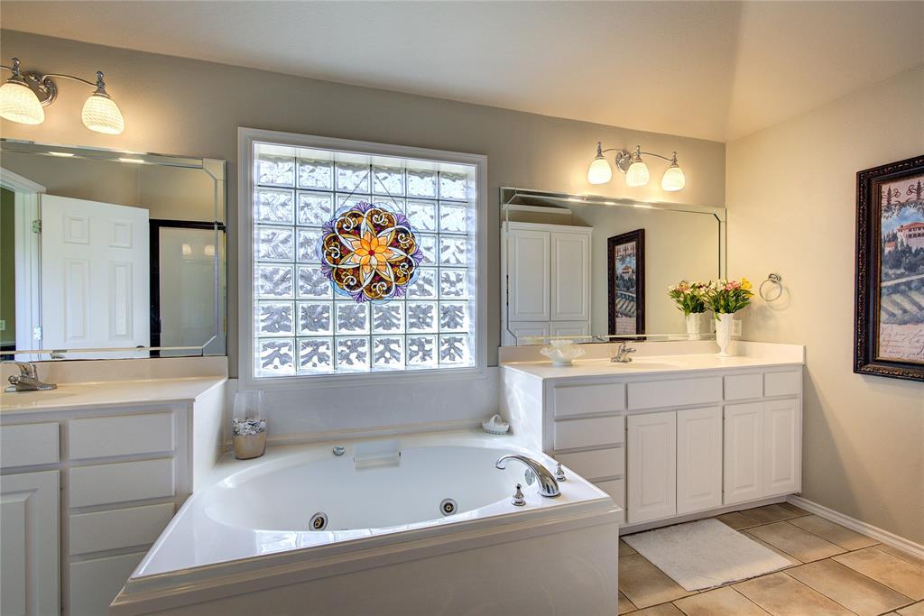 1079 Country Club Road Sulphur Springs, TX 75482 - Photo 24 of 40 a bathroom with a bathtub a sink and a window