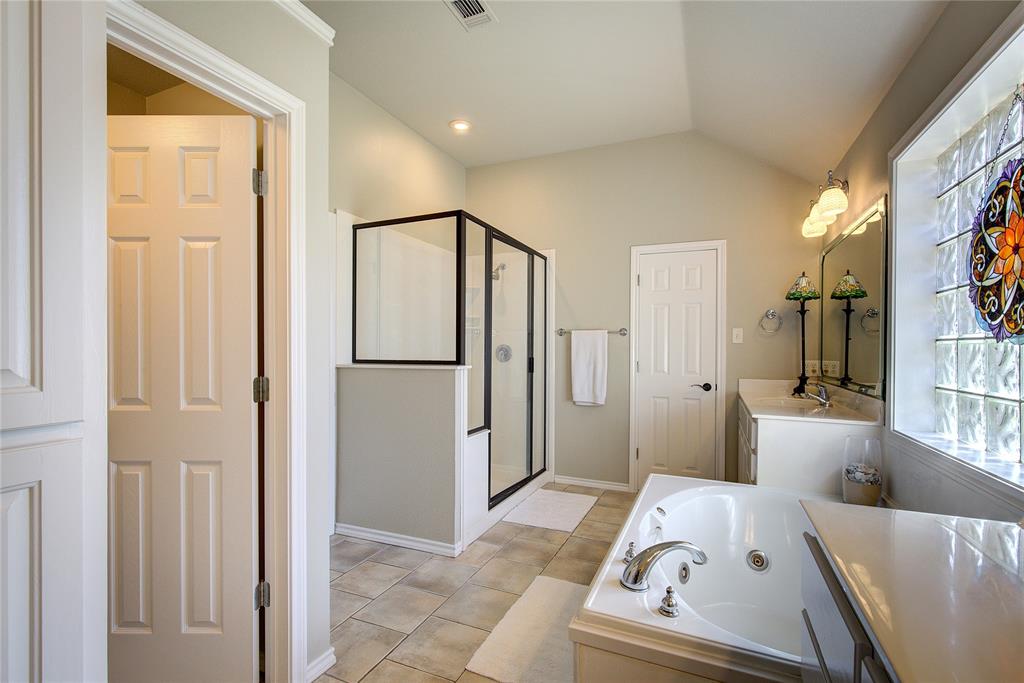 1079 Country Club Road Sulphur Springs, TX 75482 - Photo 26 of 40 a walk in closet with wooden floor and a bathroom