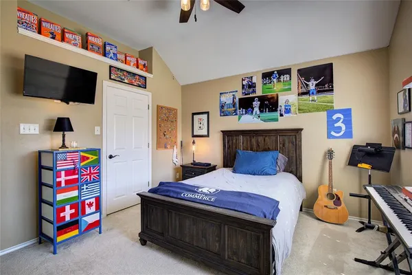a bedroom with a bed a flat screen tv and a baby crib