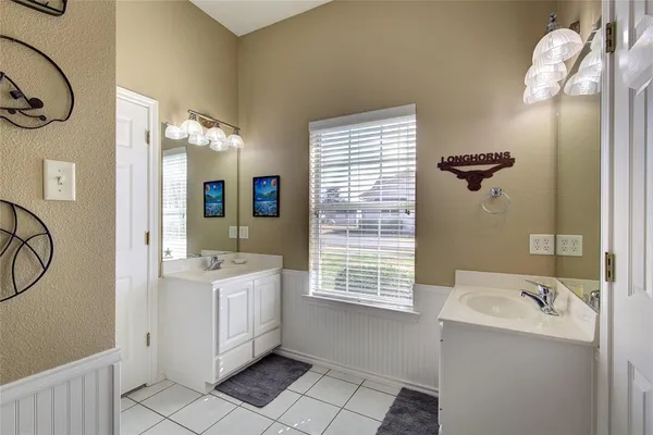 a bathroom with a bathtub sink and mirror