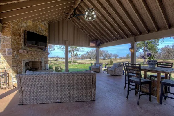 a view of an outdoor dining space with furniture and garden view