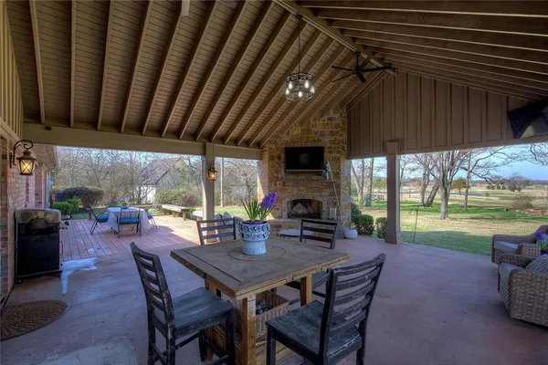 a view of a patio with a table chairs and a backyard