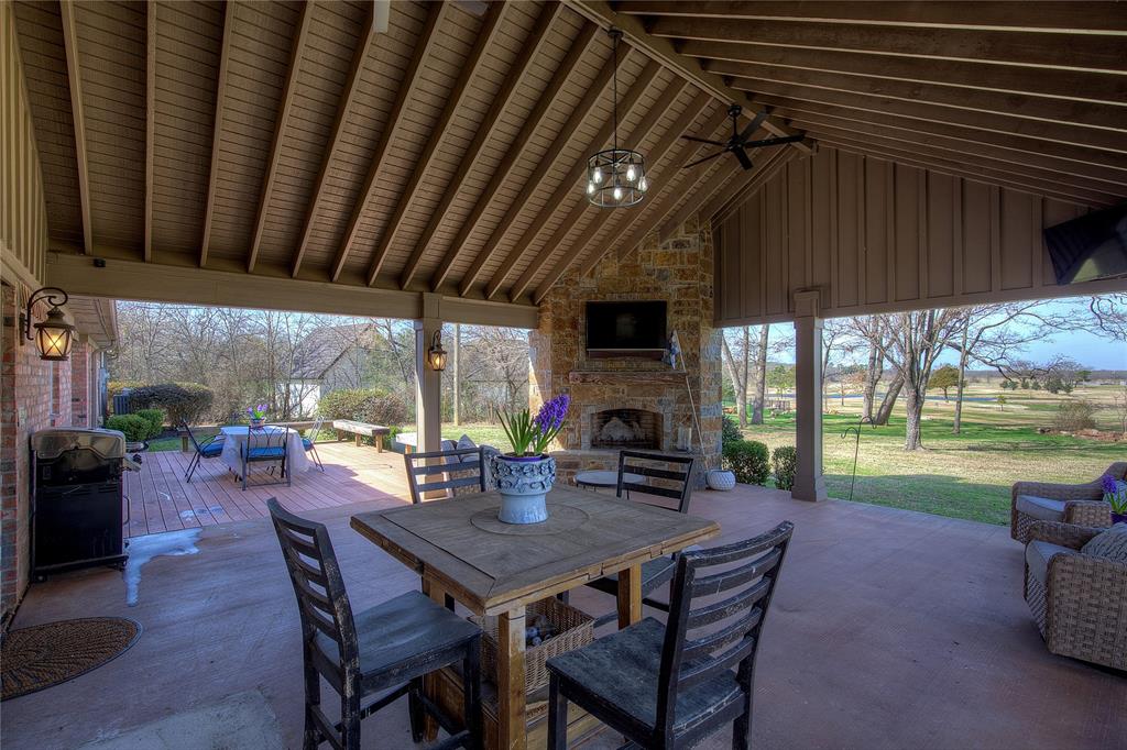 1079 Country Club Road Sulphur Springs, TX 75482 - Photo 37 of 40 a view of a patio with a table chairs and a backyard