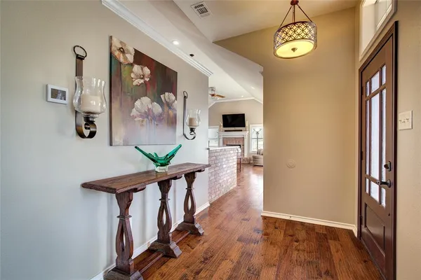 a view of entryway with furniture and wooden floor