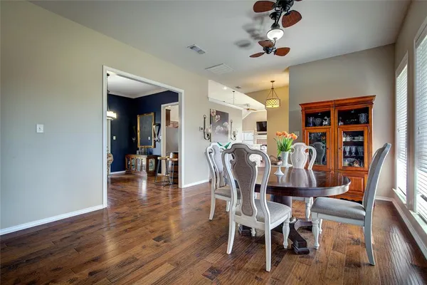 a dining room with furniture entryway and wooden floor