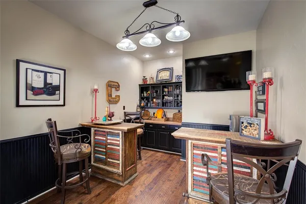 a view of a dining room with furniture wooden floor and a chandelier