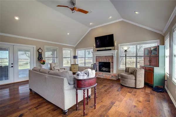 a living room with furniture flat screen tv and a fireplace