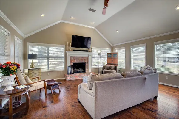 a living room with furniture fireplace and flat screen tv